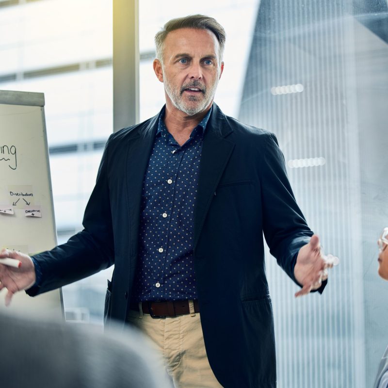 Shot of a businessman giving his staff a training seminar.